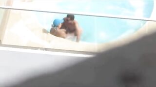 Una pareja follada en la piscina en el patio del hotel.