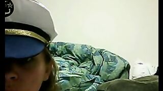 Sombra marrón desnuda gruesa en una tapa posando delante de una webcam